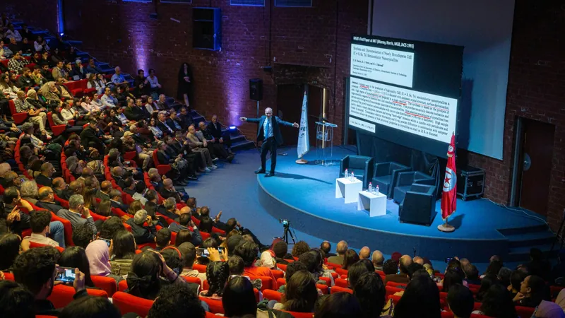 A speaker presenting to a full auditorium