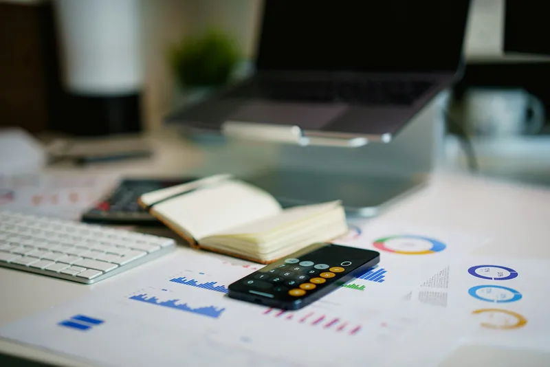 Financial reports and a calculator on an office desk
