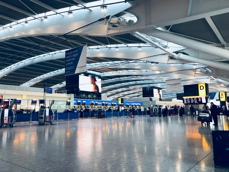 Travellers in a bright airport departure hall
