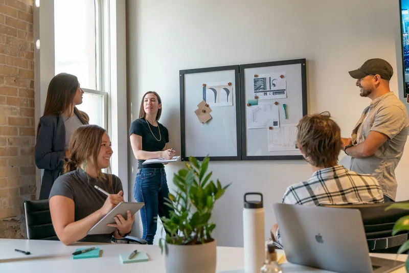A team reviewing charts together on a meeting-room board