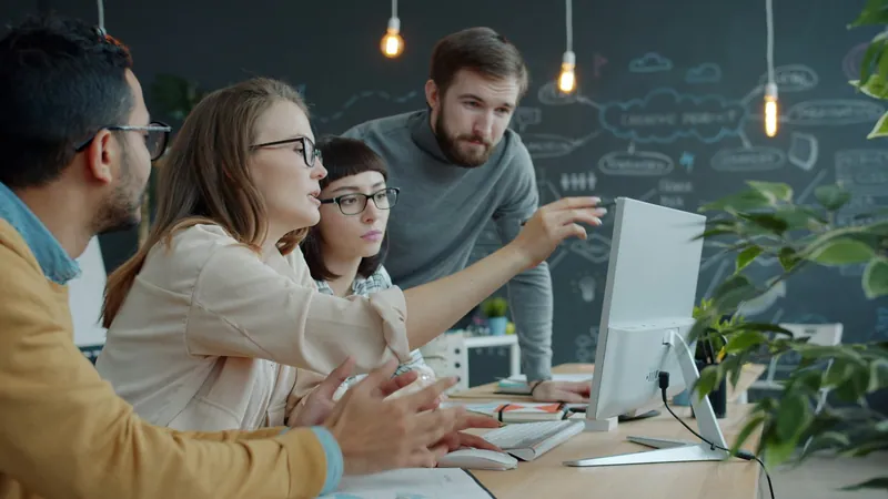 Analysts working through data together at a computer