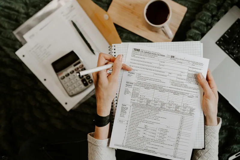 An accountant reviewing statements with a calculator