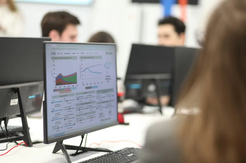 Engineers watching monitoring dashboards in an office